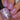 Nail polish with a pink shade and 'Hit the Bottle' text, held by a hand with matching nails.