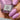 Pink nail polish bottle labeled 'Lake Tyrrell 12ml' held by a hand with matching pink nails.