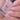 Nail polish bottle with a hand showing nails painted with a matching pink color