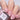 Nail polish bottle labeled 'Rose Ash Undies' with a hand displaying pink nails.