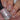 Nails with glittery nail polish over nude peel off base coat in blush colour.