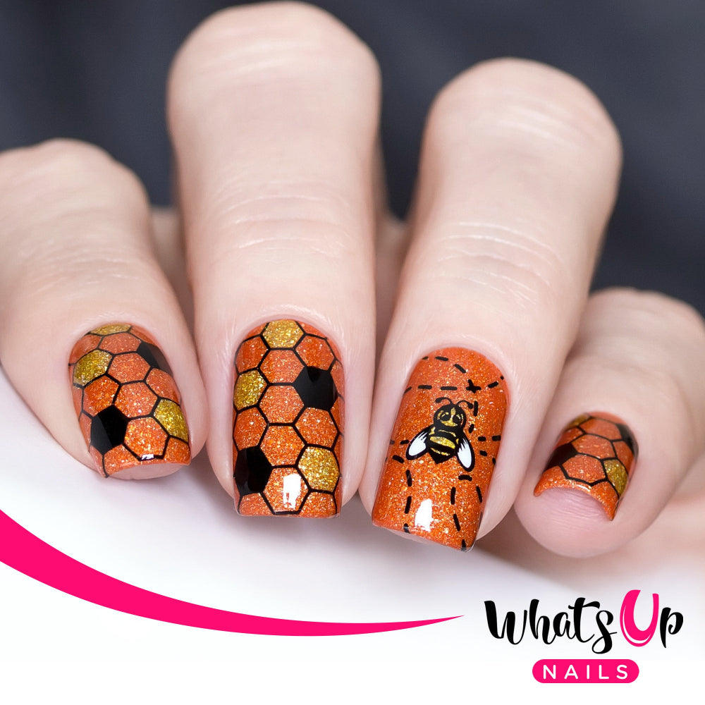 orange nails with bee design stamped over