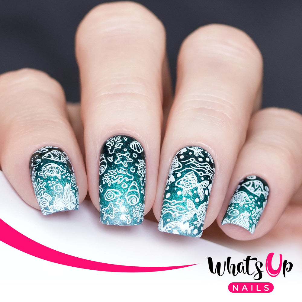 dark teal nails with white ocean animal pattern stamped over