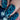 Close-up of a hand with blue geometric nail art on a blurred background