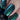 Close-up of nails with blue and green woven pattern