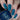 Nails with blue geometric pattern and bottle of blue nail polish