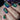 Nails with a blue and green striped pattern 
