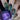 Nails with blue and green geometric pattern and a bottle of 'Hit the Bottle' nail polish.