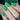 Close-up of a hand with green geometric nail art
