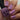 Hand with pink nail polish holding a bottle of 'Hit the Bottle' nail polish.