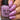 Hand holding a bottle of 'Hit the Bottle' nail polish with matching pink nails.