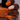 Hand with orange nail polish holding a bottle of orange nail polish with text.