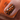 Nail with black and orange floral design on a blurred background