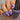 Nail polish with a metallic purple finish held by a hand, next to a bottle labeled 'Hit the Bottle'.