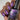 Nail polish with glittery purple  color held by a hand