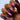 Close-up of a hand with purple glittery nail polish on a blurred background