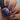 Nail polish bottle with a hand displaying nails with metallic nail polish.