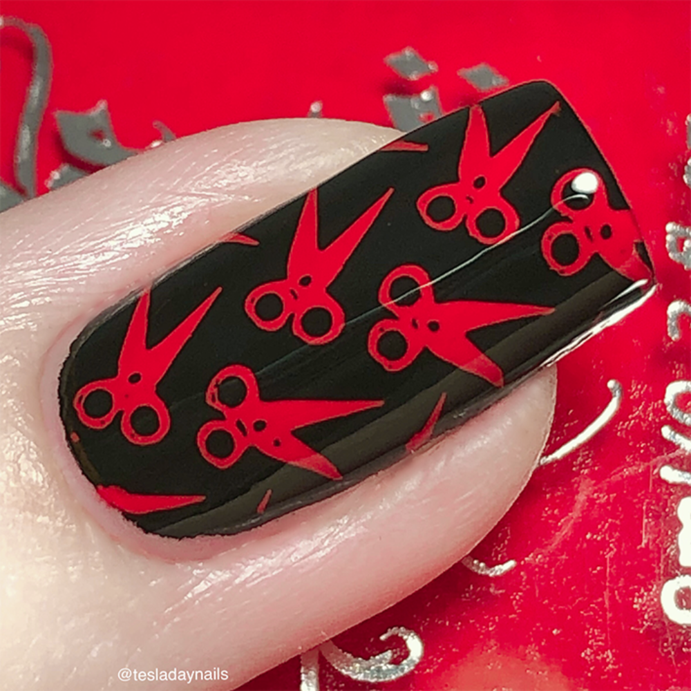 Macro red stamping polish over black