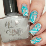 Silver-holo-polish-with-swirls-stamped-in-pale-grey-and-turquoise 