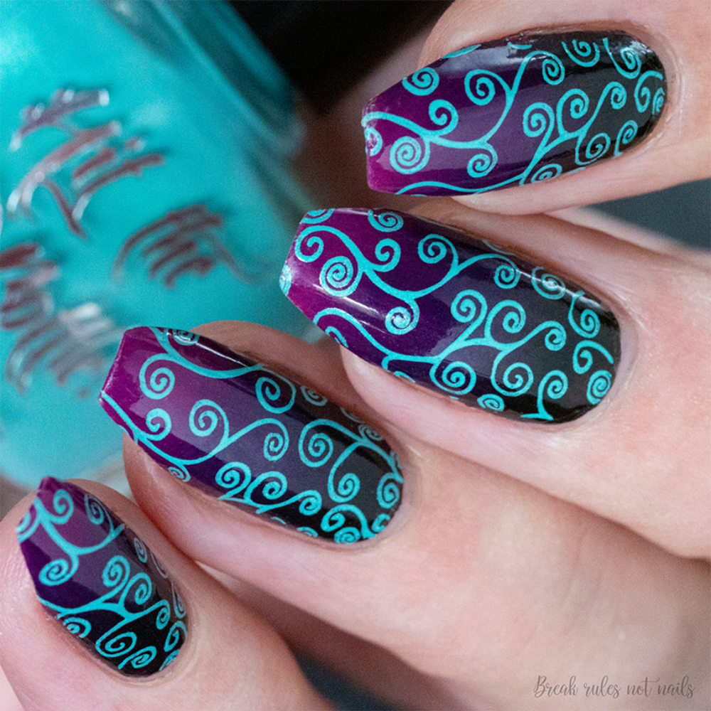 Aquamarine polish stamping over dark purple base 